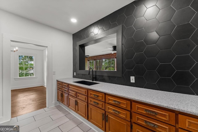 3105 Woodlawn Ave, Columbus, GA 31904 - kitchen featuring a ceiling fan, brown cabinetry, backsplash, light stone counters, and recessed lighting