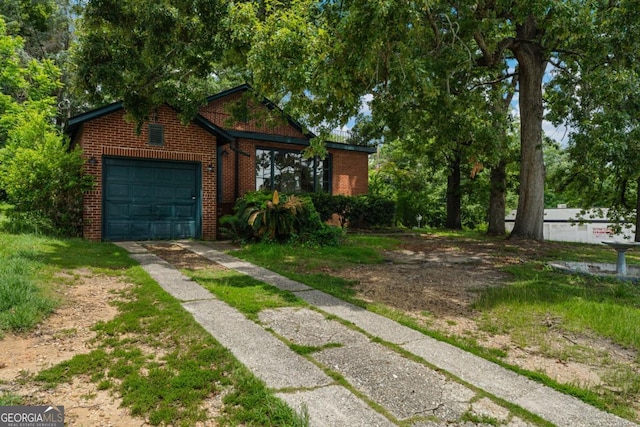 3105 Woodlawn Ave, Columbus, GA 31904 - view of front of property with concrete driveway, brick siding, and an attached garage