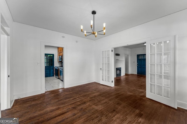 3105 Woodlawn Ave, Columbus, GA 31904 - unfurnished dining area with a chandelier, wood finished floors, french doors, and a fireplace