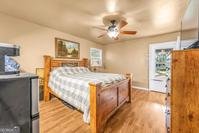 446 Thornton Rd, Washington, GA 30673 - bedroom featuring multiple windows, light wood finished floors, a ceiling fan, and freestanding refrigerator