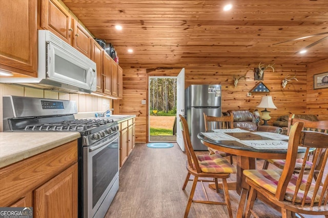 446 Thornton Rd, Washington, GA 30673 - kitchen featuring appliances with stainless steel finishes, wood ceiling, wood finished floors, light countertops, and brown cabinets