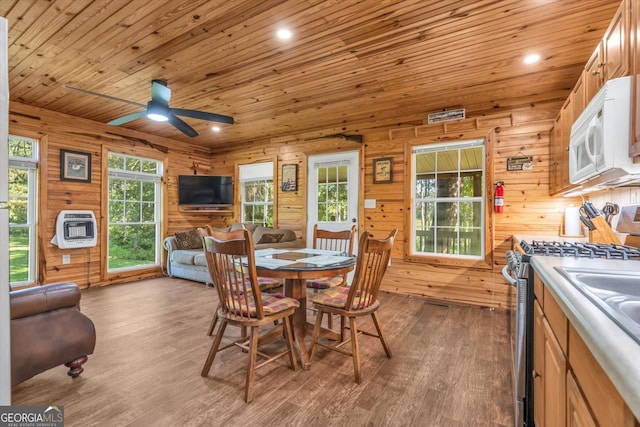 446 Thornton Rd, Washington, GA 30673 - dining room featuring heating unit, wood ceiling, wood finished floors, a ceiling fan, and wood walls