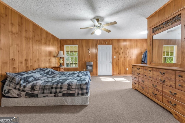 446 Thornton Rd, Washington, GA 30673 - carpeted bedroom with wooden walls, a textured ceiling, and a ceiling fan