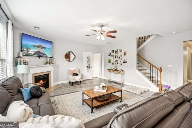 2755 Evan Manor Ln, Cumming, GA 30041 - living area with stairway, a ceiling fan, wood finished floors, and plenty of natural light