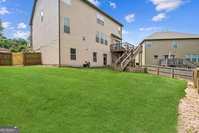 2755 Evan Manor Ln, Cumming, GA 30041 - back of property with stairs, a fenced backyard, and a deck