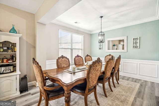 2755 Evan Manor Ln, Cumming, GA 30041 - dining room with light wood finished floors, wainscoting, and ornamental molding