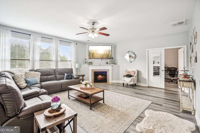 2755 Evan Manor Ln, Cumming, GA 30041 - living room featuring wood finished floors, ceiling fan, and a fireplace with flush hearth