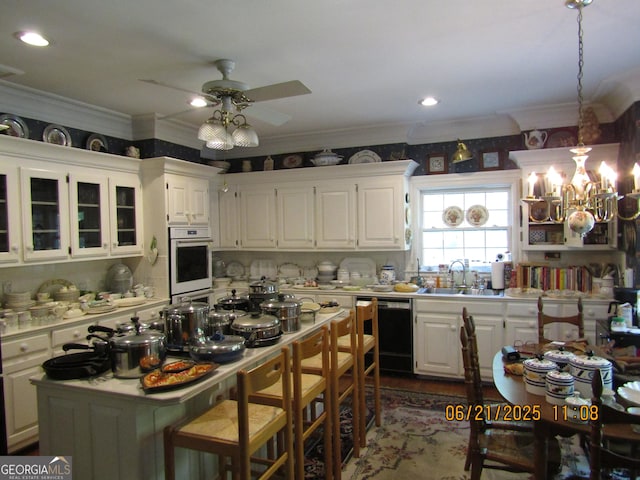 5523 Bahia Mar Cir, Stone Mountain, GA 30087 - kitchen with white oven, dishwasher, a ceiling fan, ornamental molding, and white cabinets