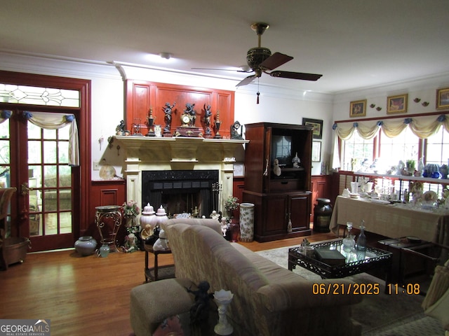 5523 Bahia Mar Cir, Stone Mountain, GA 30087 - living area featuring crown molding, ceiling fan, wood finished floors, a fireplace, and french doors