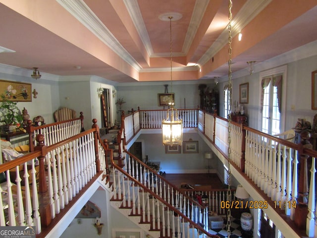 5523 Bahia Mar Cir, Stone Mountain, GA 30087 - stairway featuring ornamental molding, a raised ceiling, and a chandelier