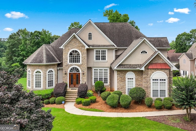 106 April Walk, Mcdonough, GA 30253 - traditional-style home with stone siding, stucco siding, a front yard, and roof with shingles
