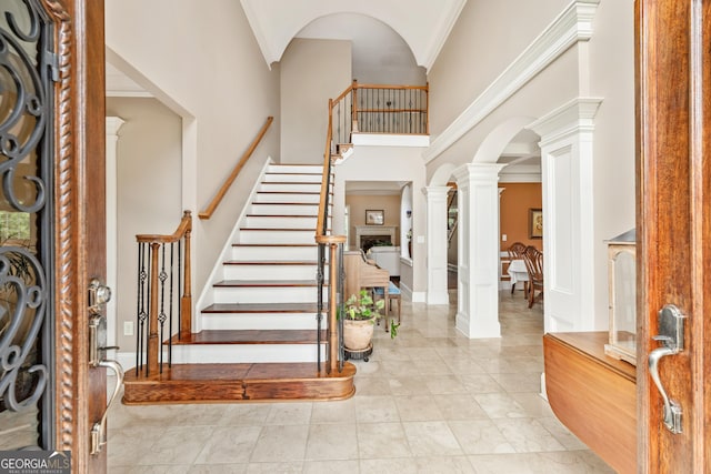 106 April Walk, Mcdonough, GA 30253 - foyer entrance with decorative columns, a high ceiling, arched walkways, and stairway
