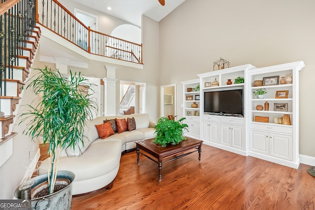 106 April Walk, Mcdonough, GA 30253 - living room with high vaulted ceiling, stairs, and wood finished floors