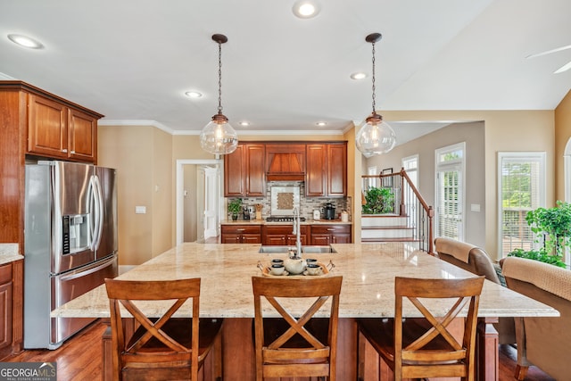 106 April Walk, Mcdonough, GA 30253 - kitchen with stainless steel appliances, light stone countertops, decorative backsplash, a breakfast bar area, and wood finished floors