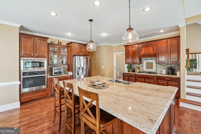 106 April Walk, Mcdonough, GA 30253 - kitchen with stainless steel appliances, custom range hood, a kitchen breakfast bar, decorative backsplash, and light wood finished floors