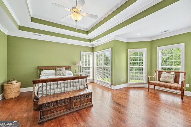 106 April Walk, Mcdonough, GA 30253 - bedroom featuring multiple windows, wood finished floors, crown molding, and a tray ceiling