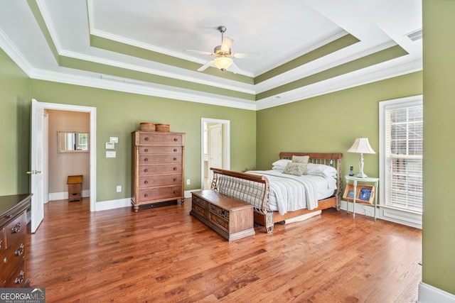 106 April Walk, Mcdonough, GA 30253 - bedroom featuring a raised ceiling, multiple windows, ornamental molding, and wood finished floors
