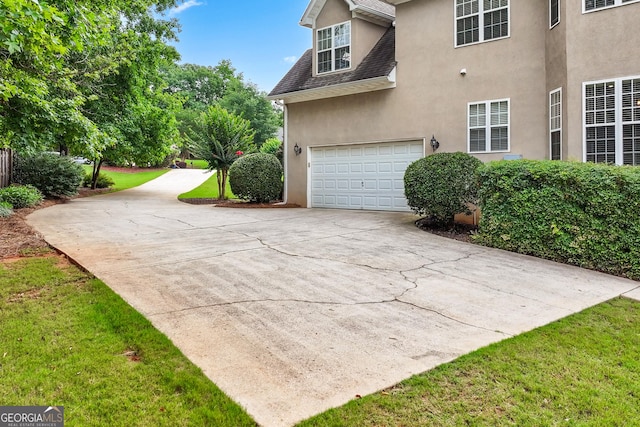 106 April Walk, Mcdonough, GA 30253 - view of home's exterior featuring stucco siding, driveway, a shingled roof, and a lawn