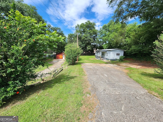 2340 Ridgeway Dr, Gainesville, GA 30504 - view of grassy yard featuring an outdoor structure and driveway