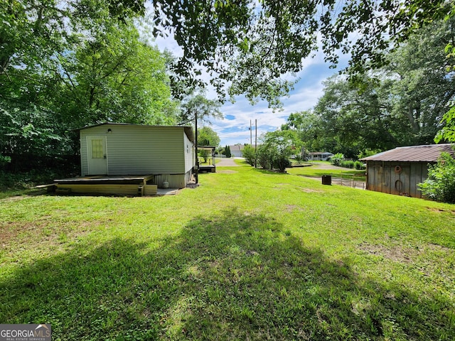 2340 Ridgeway Dr, Gainesville, GA 30504 - view of grassy yard featuring an outdoor structure and a deck