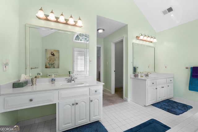 150 Tramore Trce, Tyrone, GA 30290 - bathroom with lofted ceiling, two vanities, and tile patterned flooring