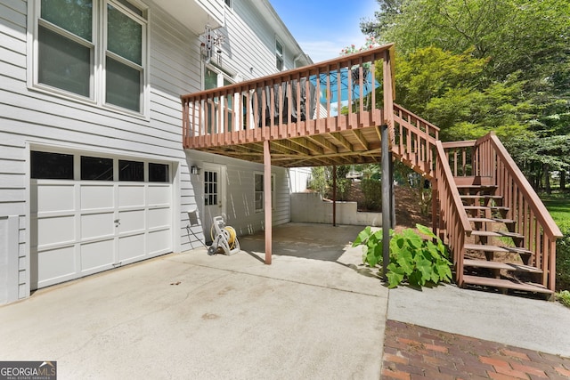 150 Tramore Trce, Tyrone, GA 30290 - view of patio with concrete driveway, stairs, a wooden deck, and an attached garage