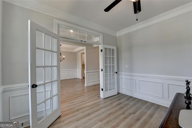 6867 Kate, Flowery Branch, GA 30542 - unfurnished room featuring french doors, crown molding, a ceiling fan, a decorative wall, and light wood finished floors