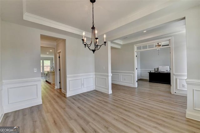 6867 Kate, Flowery Branch, GA 30542 - unfurnished dining area with a chandelier, light wood-style floors, a decorative wall, a wainscoted wall, and ornamental molding