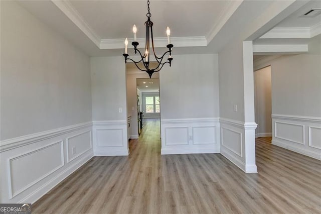 6867 Kate, Flowery Branch, GA 30542 - unfurnished dining area featuring a chandelier, light wood-style flooring, a tray ceiling, crown molding, and wainscoting