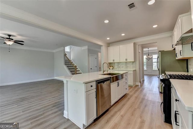 6867 Kate, Flowery Branch, GA 30542 - kitchen featuring stainless steel appliances, ornamental molding, light wood-type flooring, a ceiling fan, and decorative backsplash