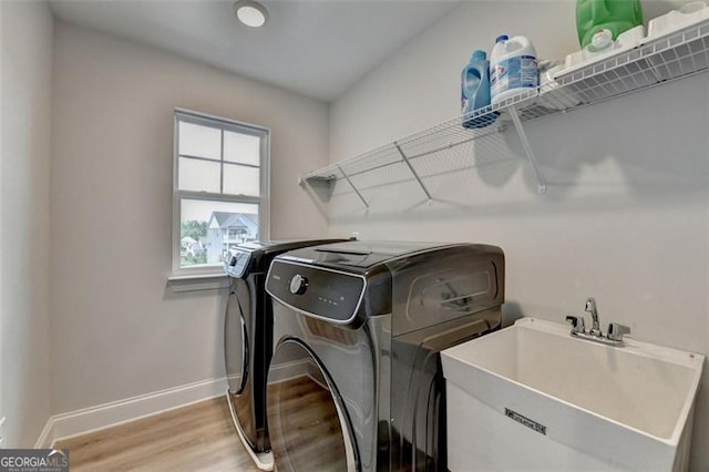6867 Kate, Flowery Branch, GA 30542 - laundry room featuring washing machine and dryer and light wood-style floors