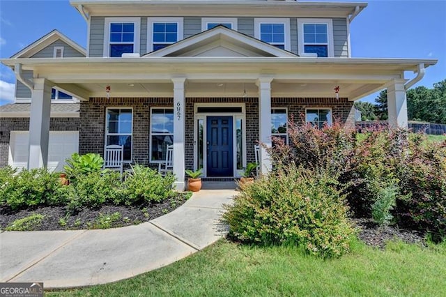 6867 Kate, Flowery Branch, GA 30542 - view of front of home with brick siding and a porch