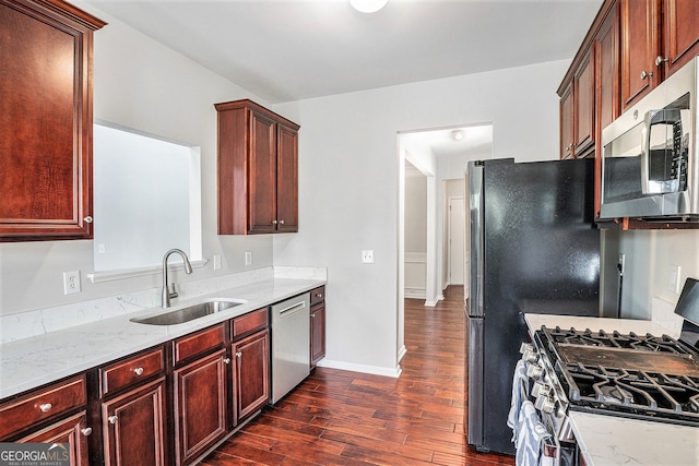 915 Pebble Creek Trl, Suwanee, GA 30024 - kitchen featuring stainless steel appliances, dark wood finished floors, light stone counters, and dark brown cabinets