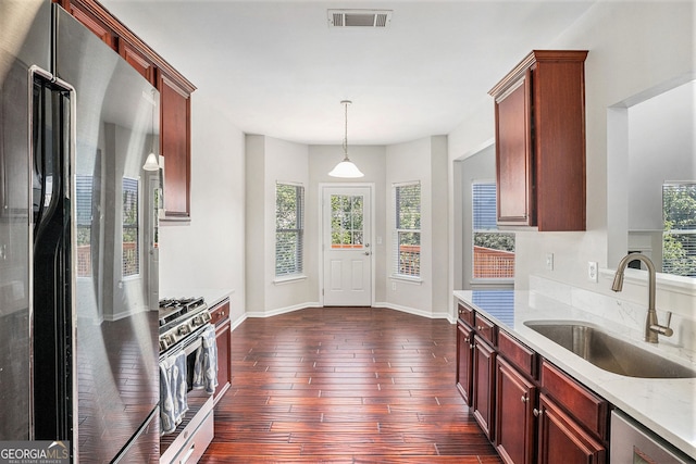 915 Pebble Creek Trl, Suwanee, GA 30024 - kitchen with freestanding refrigerator, gas stove, plenty of natural light, and dark wood finished floors
