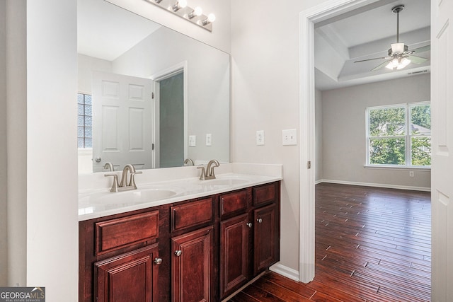 915 Pebble Creek Trl, Suwanee, GA 30024 - bathroom with wood-type flooring, a ceiling fan, double vanity, and a tray ceiling