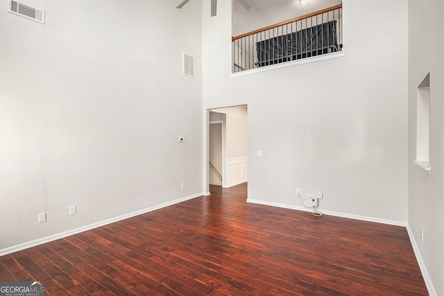 915 Pebble Creek Trl, Suwanee, GA 30024 - empty room with wood finished floors, a ceiling fan, and a towering ceiling