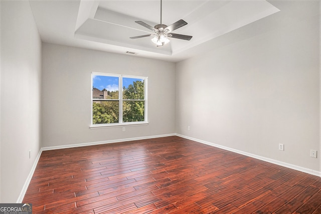 915 Pebble Creek Trl, Suwanee, GA 30024 - empty room with a tray ceiling, dark wood-style floors, and ceiling fan