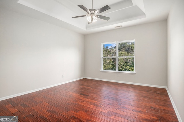 915 Pebble Creek Trl, Suwanee, GA 30024 - empty room with a raised ceiling, ceiling fan, and dark wood-style floors