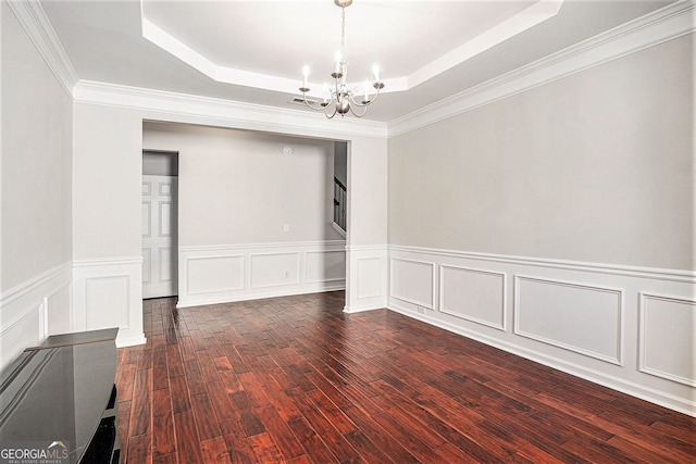915 Pebble Creek Trl, Suwanee, GA 30024 - empty room featuring a chandelier, a tray ceiling, dark wood-style flooring, a wainscoted wall, and stairs