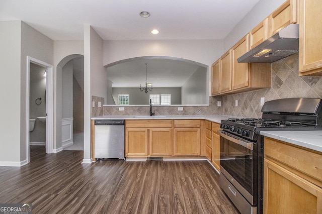 801 Tulip Poplar Way Unit 2501, Lawrenceville, GA 30044 - kitchen featuring stainless steel appliances, under cabinet range hood, arched walkways, dark wood finished floors, and light countertops