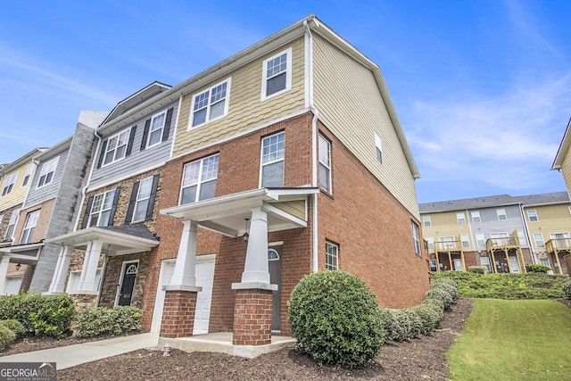 801 Tulip Poplar Way Unit 2501, Lawrenceville, GA 30044 - view of front of home featuring brick siding, an attached garage, and concrete driveway