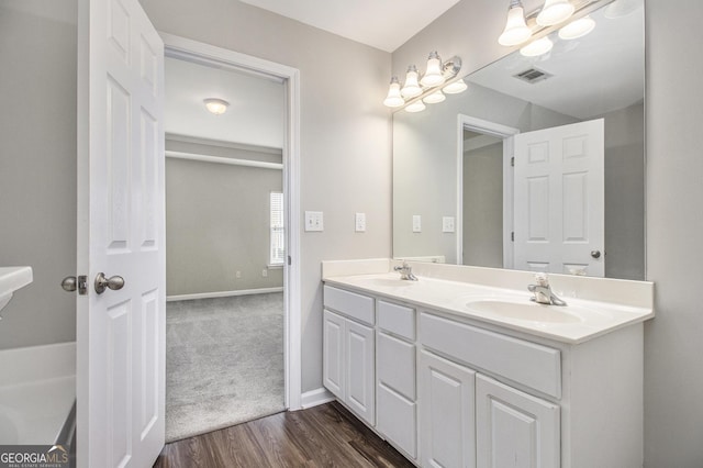 801 Tulip Poplar Way Unit 2501, Lawrenceville, GA 30044 - bathroom featuring double vanity and wood finished floors