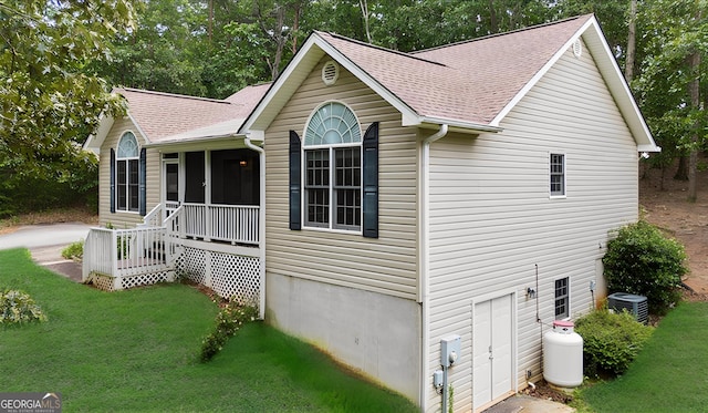 205 River Flow Dr, Dahlonega, GA 30533 - view of front of home featuring a sunroom, a shingled roof, and a front lawn
