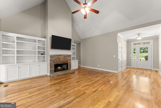 379 Sweetwater Rdg, Hoschton, GA 30548 - unfurnished living room with a ceiling fan, light wood-style floors, a fireplace, high vaulted ceiling, and crown molding