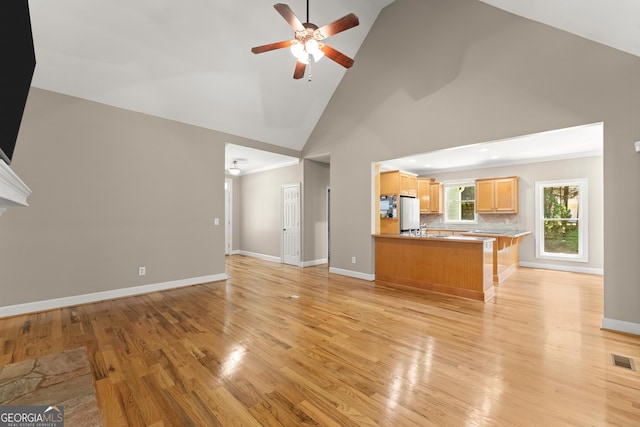 379 Sweetwater Rdg, Hoschton, GA 30548 - unfurnished living room with ceiling fan, light wood finished floors, and high vaulted ceiling