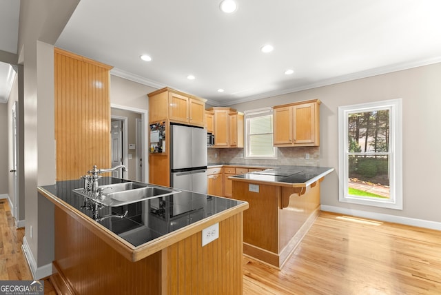 379 Sweetwater Rdg, Hoschton, GA 30548 - kitchen with appliances with stainless steel finishes, a peninsula, light wood-type flooring, ornamental molding, and healthy amount of natural light