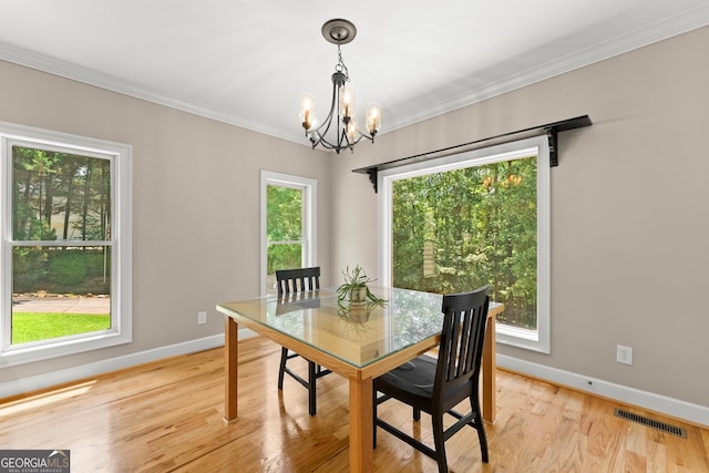 379 Sweetwater Rdg, Hoschton, GA 30548 - dining space featuring a chandelier, light wood finished floors, and ornamental molding