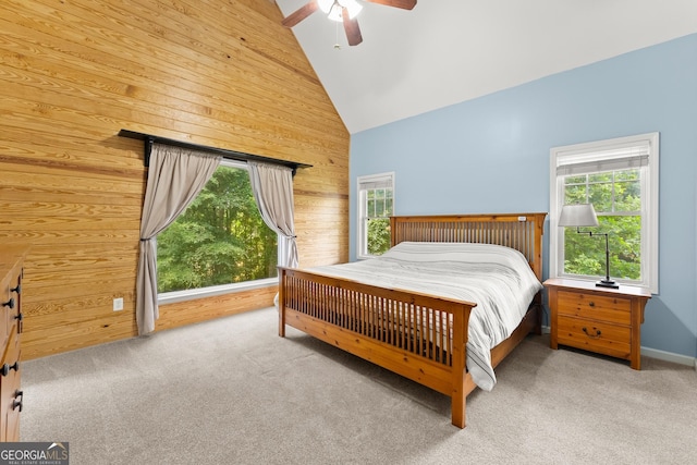 379 Sweetwater Rdg, Hoschton, GA 30548 - carpeted bedroom featuring wooden walls, multiple windows, ceiling fan, and high vaulted ceiling