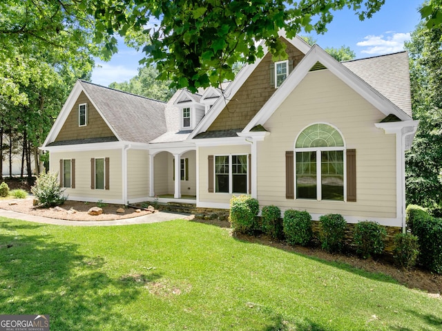 379 Sweetwater Rdg, Hoschton, GA 30548 - view of front of house featuring a porch, a front yard, and roof with shingles