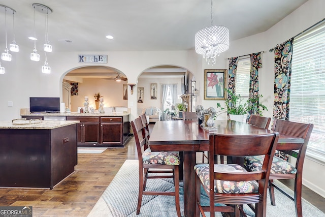 312 Sierra Ct, Mcdonough, GA 30253 - dining area featuring arched walkways, light wood-style flooring, plenty of natural light, and recessed lighting